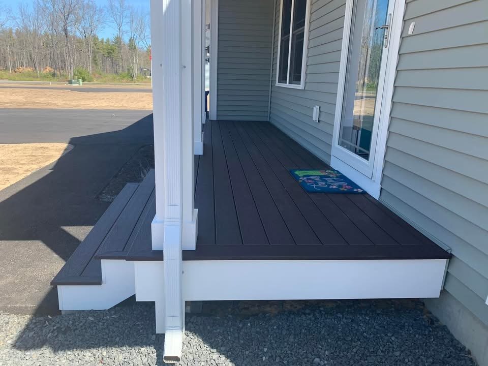 Composite front porch decking with white trim and steps