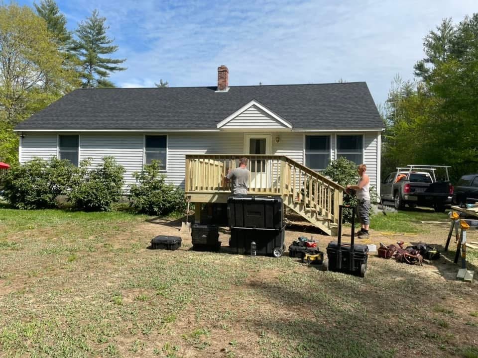 Crew building a new pressure-treated deck and stairs in Maine