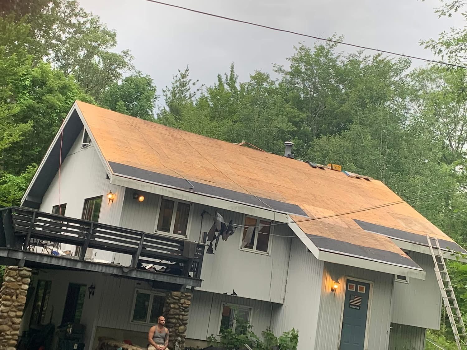 New roof sheathing and ice-and-water shield installed before shingles