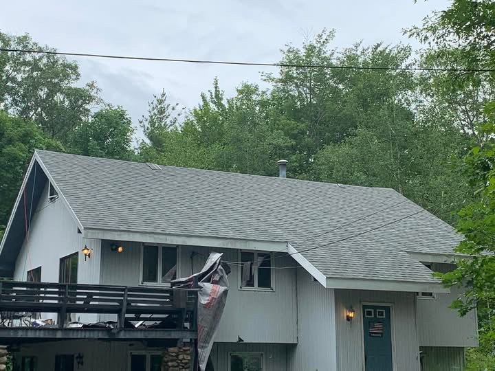 Completed gray shingle roof replacement on a Maine chalet