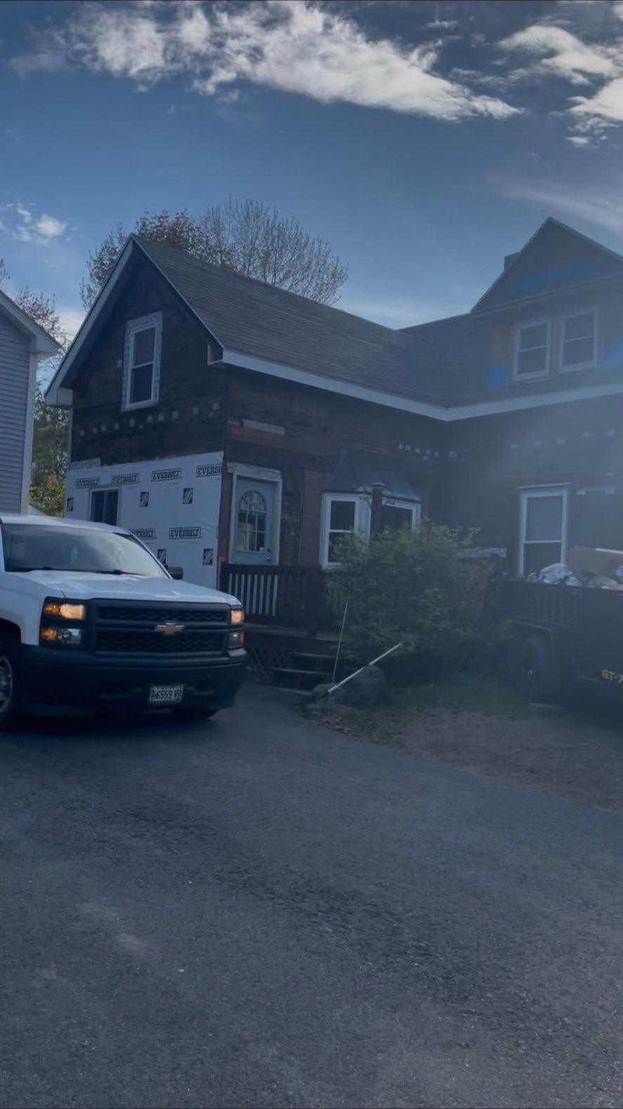 Exterior siding and house wrap work underway on a Maine home