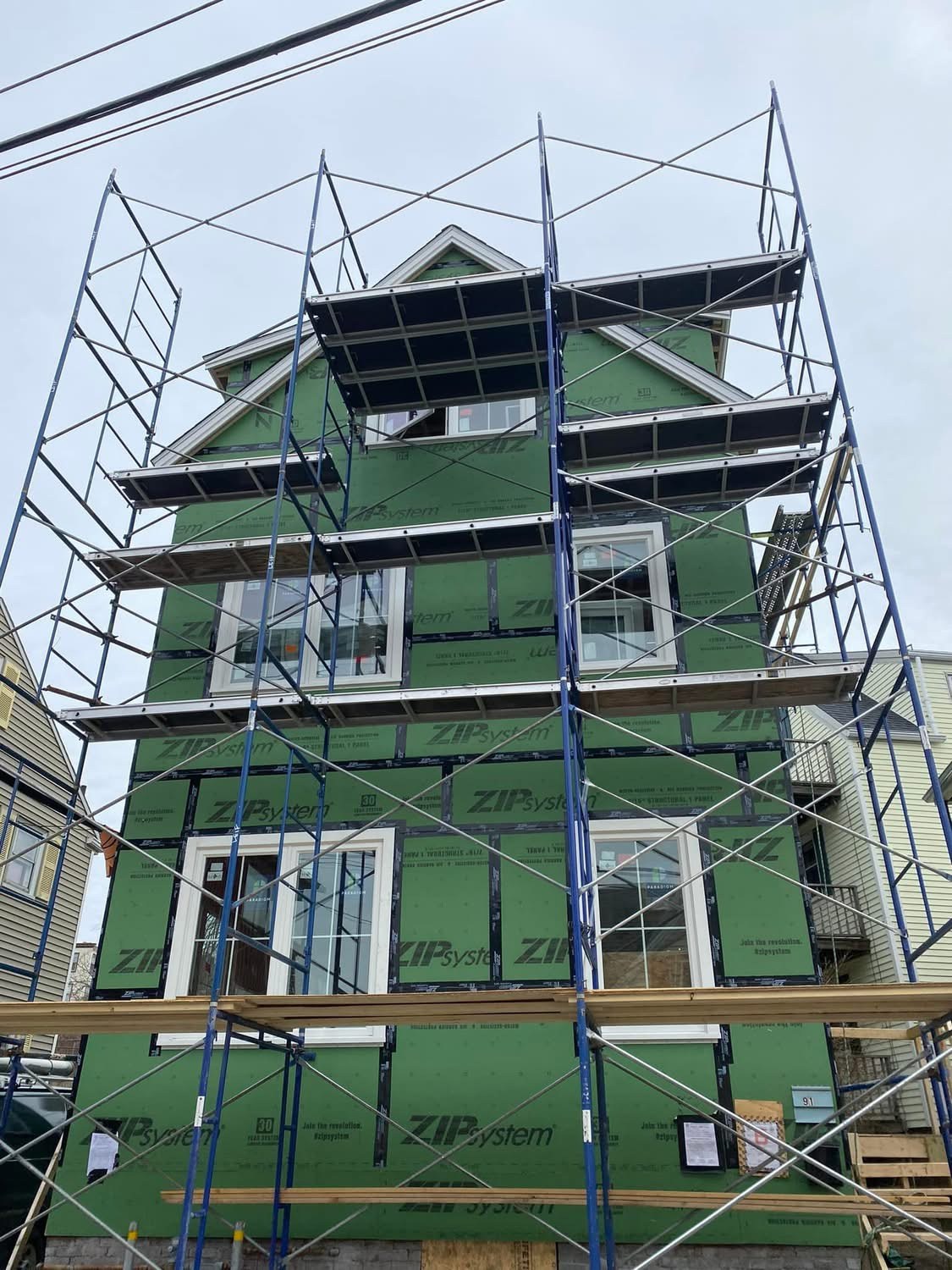 Structural sheathing and window install with full scaffolding